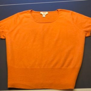 Short sleeved light orange cashmere sweater.